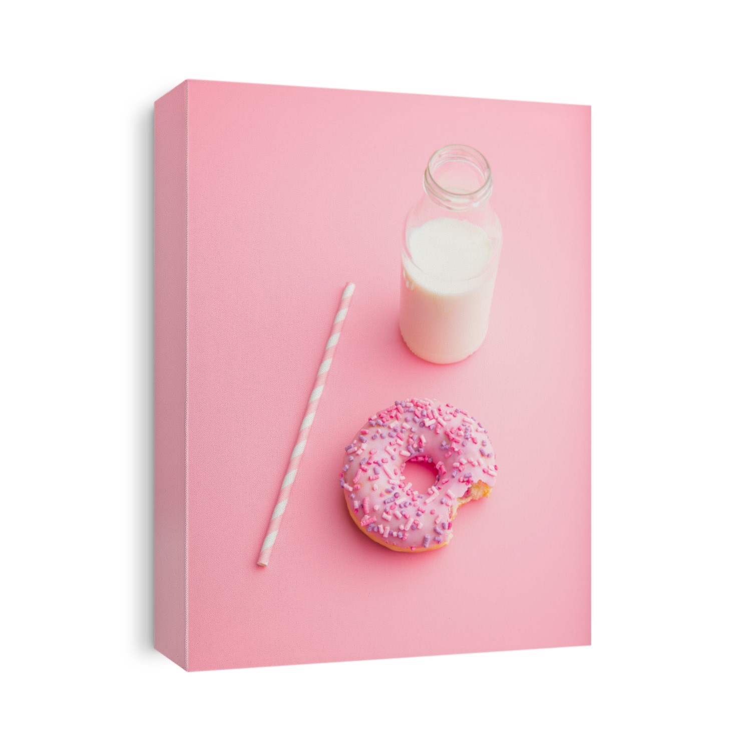 Pink donut and milk bottle on pink background.